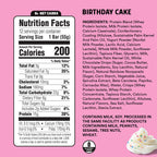 Nutrition facts label and ingredients list for a birthday cake-flavored protein bar on a pink background.
