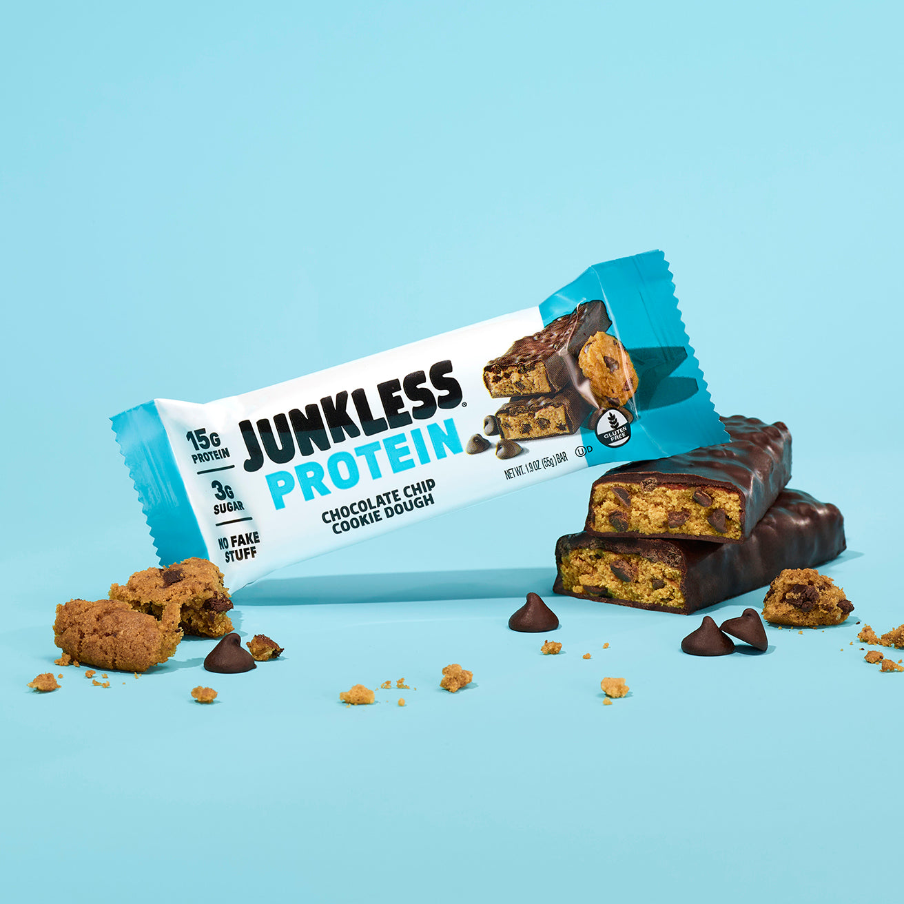 Junkless Protein Chocolate Chip Cookie Dough bar with packaging on a light blue background