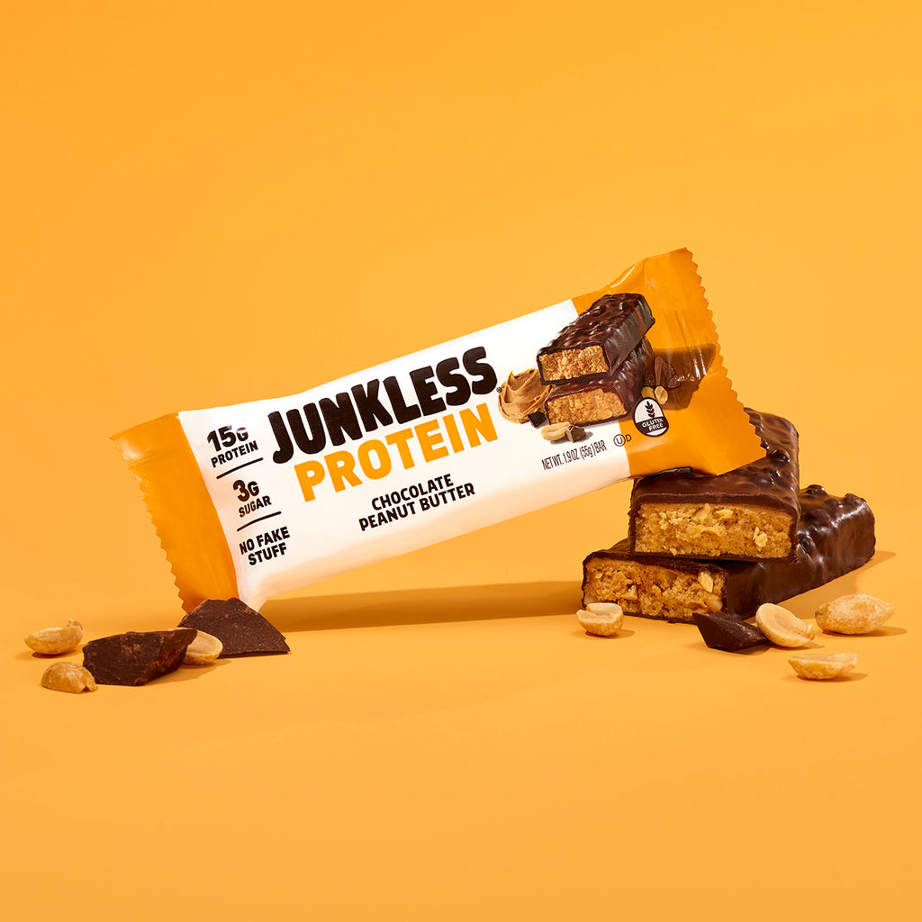 Junkless Protein chocolate peanut butter bar on a yellow background