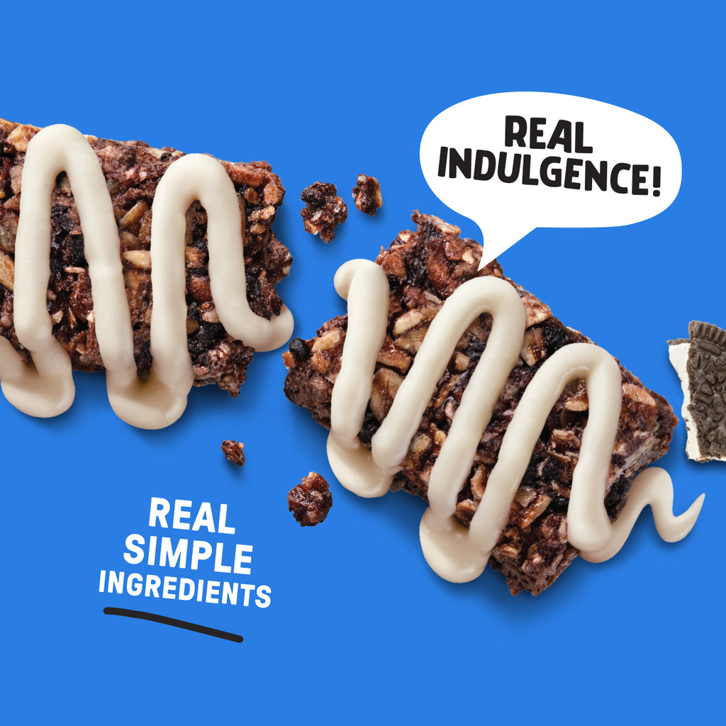 Chocolate bar with white drizzle on a blue background, featuring text 'Real Indulgence!' and 'Real Simple Ingredients'.