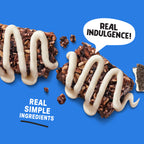Chocolate bar with white drizzle on a blue background, featuring text 'Real Indulgence!' and 'Real Simple Ingredients'.