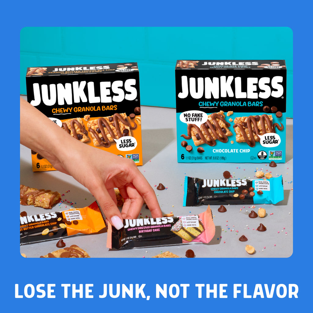 Junkless chewy granola bars packaging with a hand holding one bar on a blue background.
