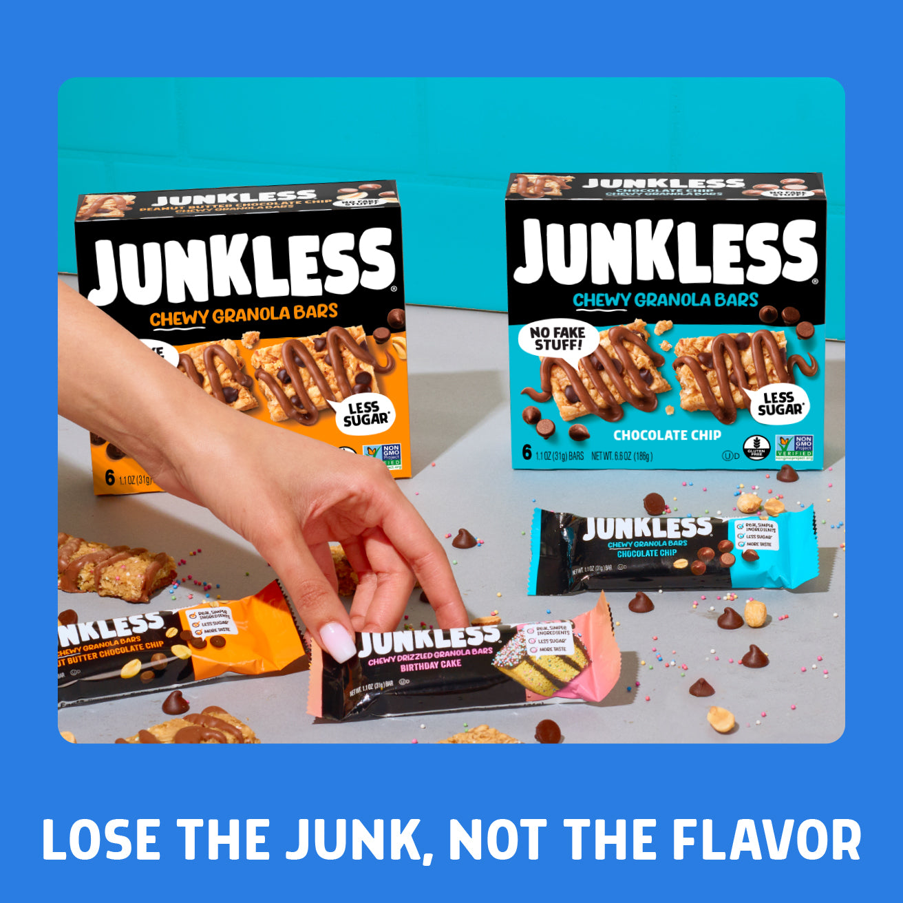Junkless chewy granola bars packaging with a hand holding one bar on a blue background.