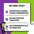 Promotional graphic with a white rounded rectangle listing three claims: no fake stuff, no artificial flavors/colors/preservatives, and no high fructose corn syrup or hydrogenated oils or trans fats. The background is purple and lime green with cartoon illustrations of a green monster and a white ghost.