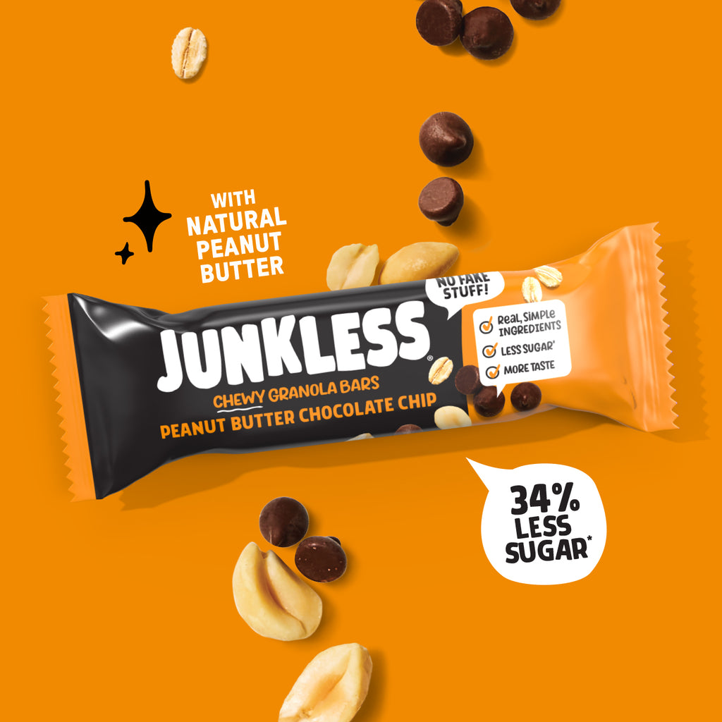 Junkless peanut butter chocolate chip granola bar on an orange background with peanuts and chocolate chips.