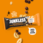 Junkless peanut butter chocolate chip granola bar on an orange background with peanuts and chocolate chips.