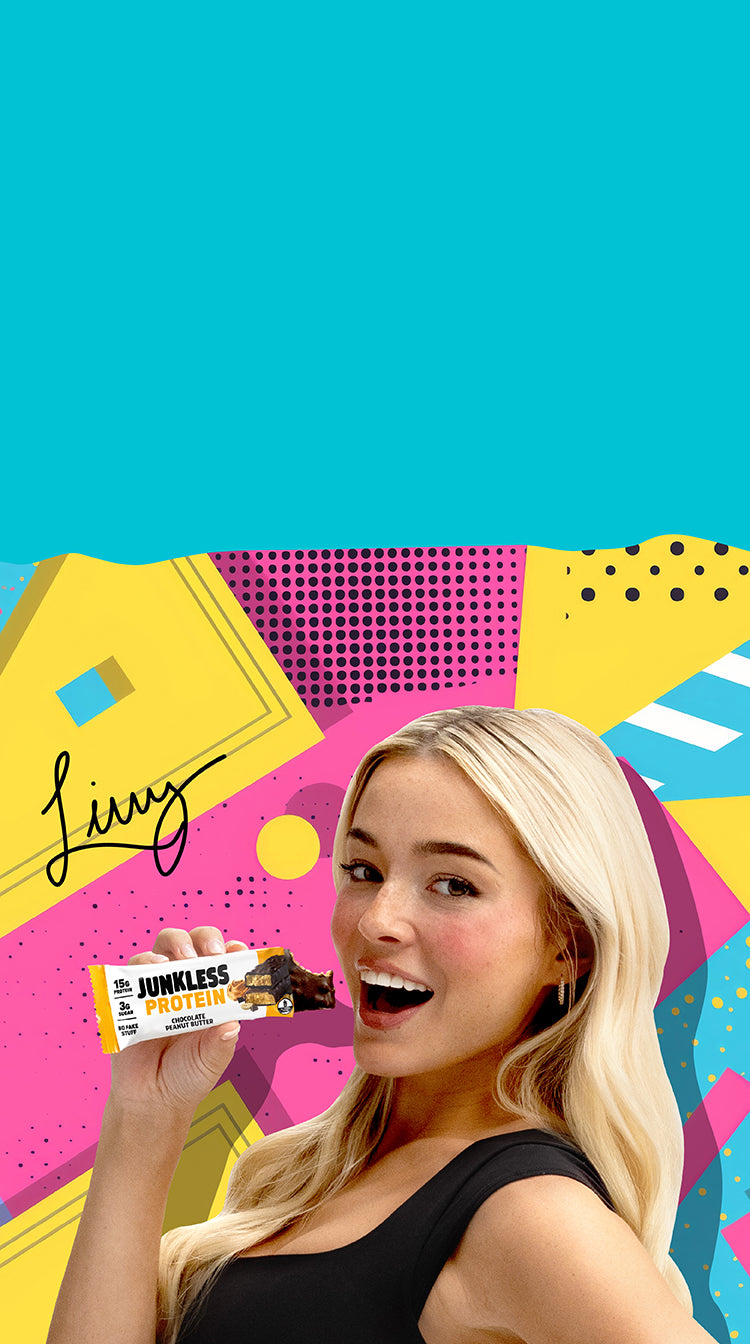 Livvy Dunne holding a Junkless Chocolate Peanut Butter Protein Bar.