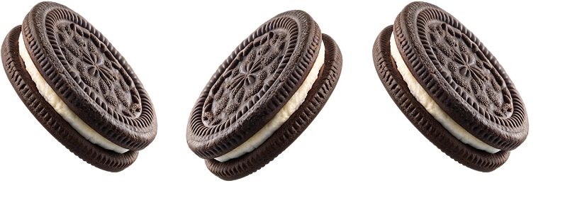 Three chocolate cookies with white frosting filling on a white background