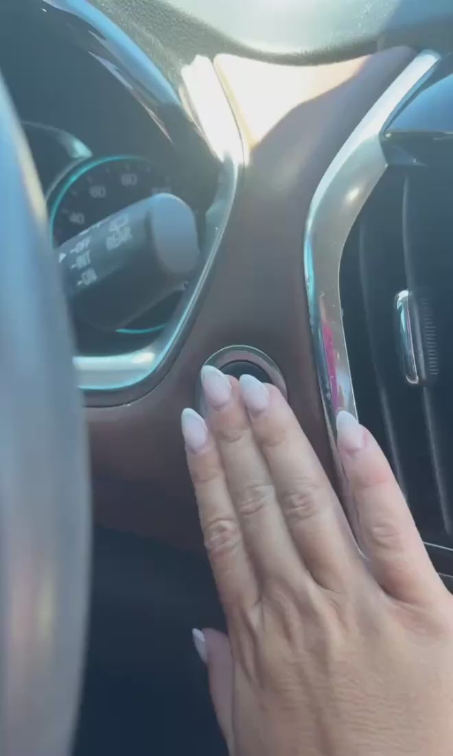 granola bar with hand in a car on a steering wheel
