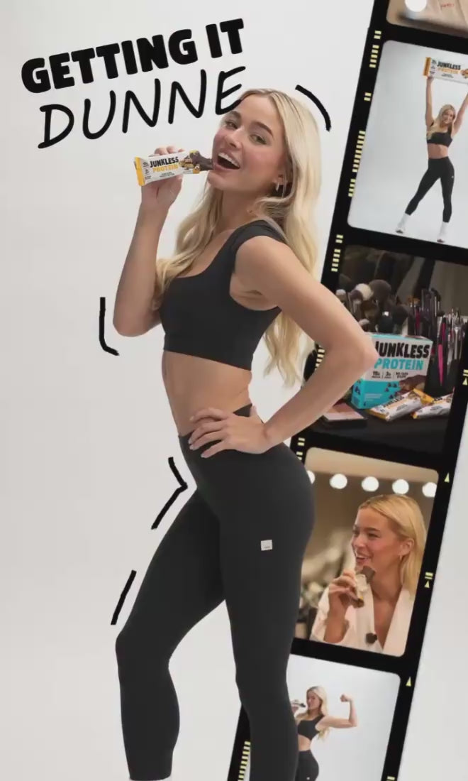Livvy Dunne eating a junkless protein bar next to film roll from a photo shoot on a white background