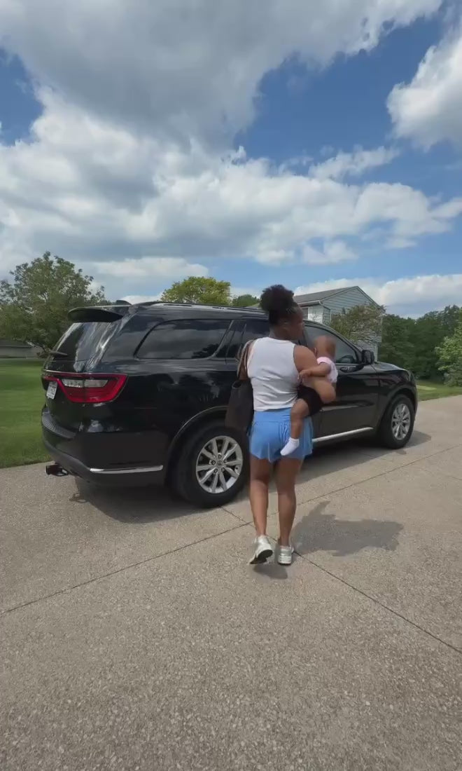 Mom walking with child to car.