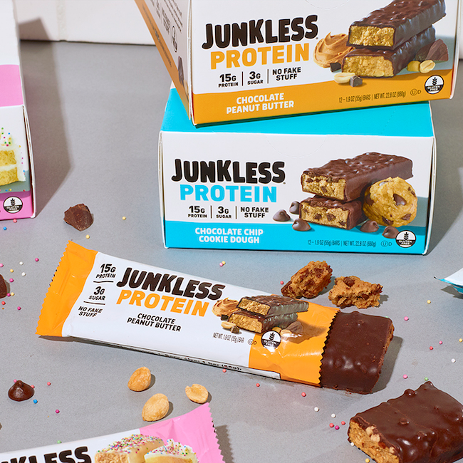 Junkless Protein bars and packaging on a gray surface